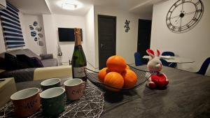 a table with a bowl of oranges and a bottle of wine at Les Arts in Valencia