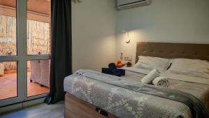 a bedroom with a large bed and a balcony at Les Arts in Valencia