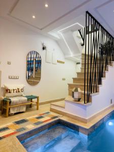 a house with a pool in the middle of a living room at RIAD El Ma in Marrakesh