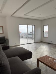a living room with a couch and a coffee table at Caetana e Ferro in Calheta