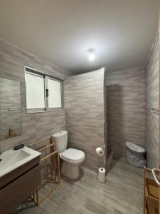 a bathroom with a toilet and a sink at Caetana e Ferro in Calheta +19 photos