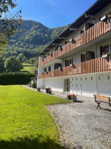 a building with a bench in front of it at Pretty Mountain View 2-bedroom Pyrenees Apartment in Saint-Béat