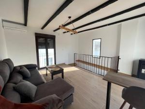 a living room with a couch and a table at Villa Marín in Aroche
