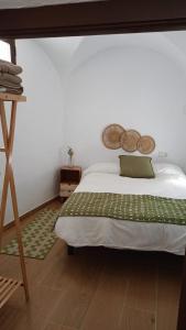 a bedroom with a large bed and a wooden floor at Villa Marín in Aroche