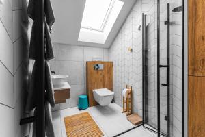 a bathroom with a toilet and a sink at Wiatr od morza Jantar - BursztynoveLove in Jantar +32 photos