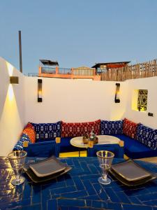 a room with tables and chairs and a couch at RIAD El Ma in Marrakesh