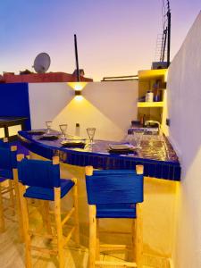 a bar with blue chairs and a blue counter at RIAD El Ma in Marrakesh