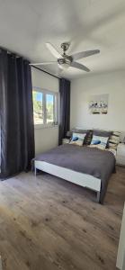 a bedroom with a bed and a ceiling fan at Villa Ružmarin in Lovište +59 photos
