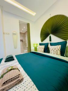 a bedroom with a large blue bed with pillows at RIAD El Ma in Marrakesh +21 photos
