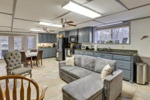 a living room with a couch and a kitchen at Private Boat Launch! Riverfront Jefferson Retreat in Jefferson