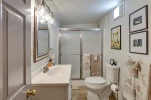 a white bathroom with a toilet and a sink at Private Boat Launch! Riverfront Jefferson Retreat in Jefferson +28 photos