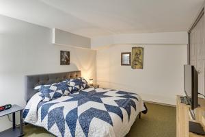 a bedroom with a blue and white bed and a tv at Private Boat Launch! Riverfront Jefferson Retreat in Jefferson