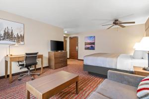 a hotel room with a bed and a desk at Quality Inn near Rocky Mountain National Park in Estes Park