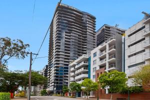 a group of tall buildings on a city street at Brisbane One Views Level 15 2BR Apartment in Brisbane