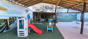 a play room with a slide and a playground at Hotel Punta del Mar in Máncora Chico