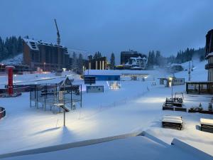 a ski resort covered in snow at night at Krčma Jahorina in Jahorina