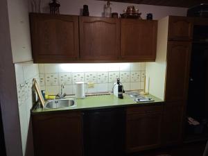 a kitchen with a sink and a counter top at Nassfeld Sonnleitn by Semi in Hermagor +6 photos