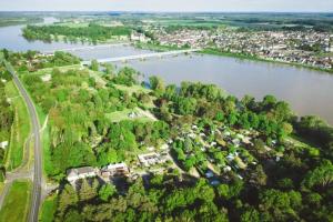 an aerial view of a town next to a river at ZEcamping 3 étoiles - bord de Loire - proximité directe des châteaux in Sully-sur-Loire +47 photos