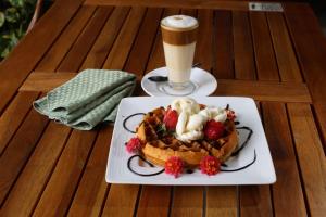 a plate of waffles and a drink on a table at Holiday Inn Orizaba by IHG in Orizaba