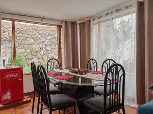 a dining room with a table and chairs and a window at UMAY lodge house in Urubamba