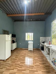 an empty kitchen with blue walls and white appliances at Recanto do 7 in Presidente Figueiredo +15 photos