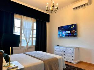 a bedroom with a bed and a tv on the wall at Villa COLONIAL in Vilaseca de Solcina +54 photos