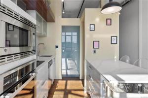 a kitchen with white counters and a large appliance at Downtown one bedroom apartment 2 in Victoria