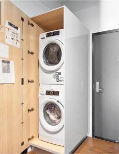 a laundry room with two washer and dryer at Downtown one bedroom apartment 2 in Victoria