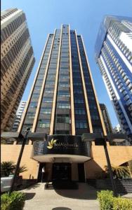 a tall building with a sign in front of it at Hotel & Residence Alphaville in Barueri