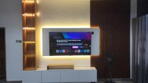 a flat screen tv on a wall in a room at Lakatabu Apartments in Mama