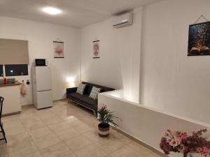 a living room with a couch and a refrigerator at Vivienda LorenNani in El Paso