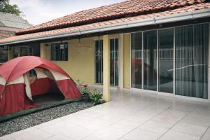 a tent is set up outside of a house at HosteldaRo in Penha