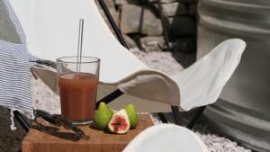 a drink sitting on a chair with a plate of fruit at Mas Labrugade in Lebreil