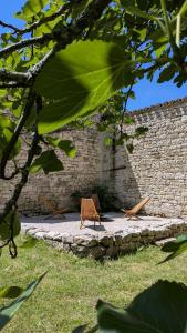 a wooden bench sitting in front of a brick wall at Mas Labrugade in Lebreil +75 photos