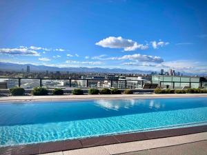 a large swimming pool on top of a building at Cherry Creek Rooftop Oasis in Denver