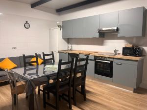 a kitchen with a table and chairs in a room at Finca Rural Marmito in Sanlúcar de Barrameda