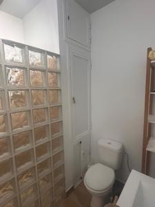 a bathroom with a toilet and a wall of drawers at Finca Rural Marmito in Sanlúcar de Barrameda +13 photos