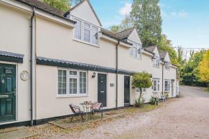 a row of white houses with chairs and a table at 2 Bed in Peterstow oc-w33537 in Peterstow