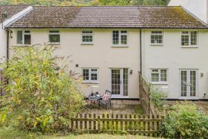 a white house with a wooden fence in front of it at 2 Bed in Peterstow oc-w33537 in Peterstow +14 photos