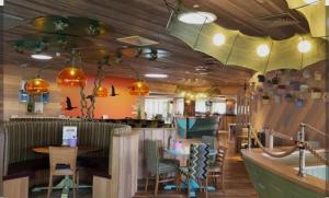 a restaurant with a bar with a table and chairs at Denny's Holiday Homes in Blackpool