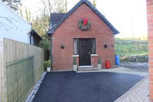 a red brick house with a wreath on the door at The Fairways, CastleBlayney in Castleblayney