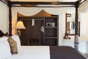 a hotel room with a bed and a microwave at Hotel Posada Virreyes in Guadalajara +87 photos