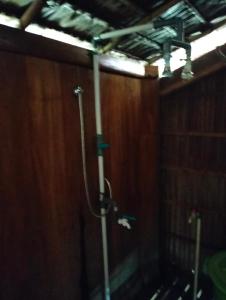 a shower in a bathroom with a wooden wall at Bruno Raja Ampat Homestay in Pulau Mansuar +30 photos