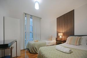 a hotel room with two beds and a window at Hub Retreat in Milton Keynes