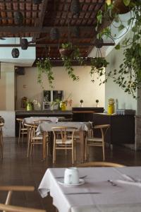 a restaurant with tables and chairs in a room at Hotel Posada Virreyes in Guadalajara