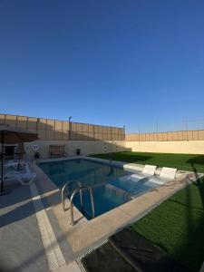 a large swimming pool in front of a building at شاليه الدرة Durra Chalet in Amman +7 photos