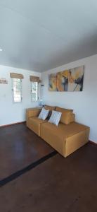 a living room with a brown couch in a room at Mirabela Casa con vista panorámica a las sierras en Bialet Massé- Hasta 4 personas in Bialet Massé