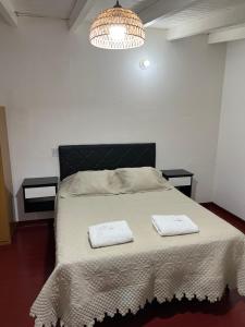 a bedroom with a bed with two towels on it at Eucalipto Dúplex in San Vicente