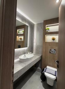 a bathroom with a sink and a toilet at Bright 7th floor Studio-Near Center of Xanthi in Xanthi +3 photos