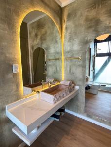 a bathroom with a sink and a large mirror at Bed & Breakfast Casa Ziré in Navidad +78 photos